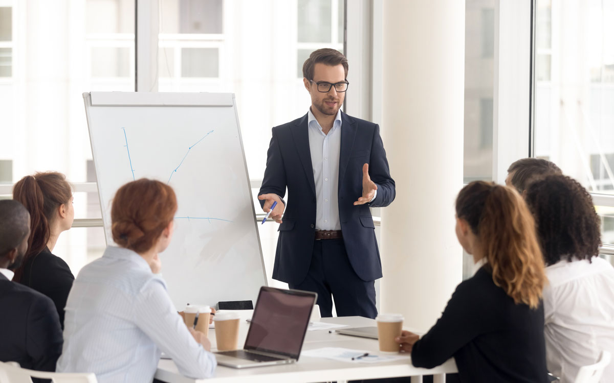 Male business coach speaker in suit give flipchart presentation